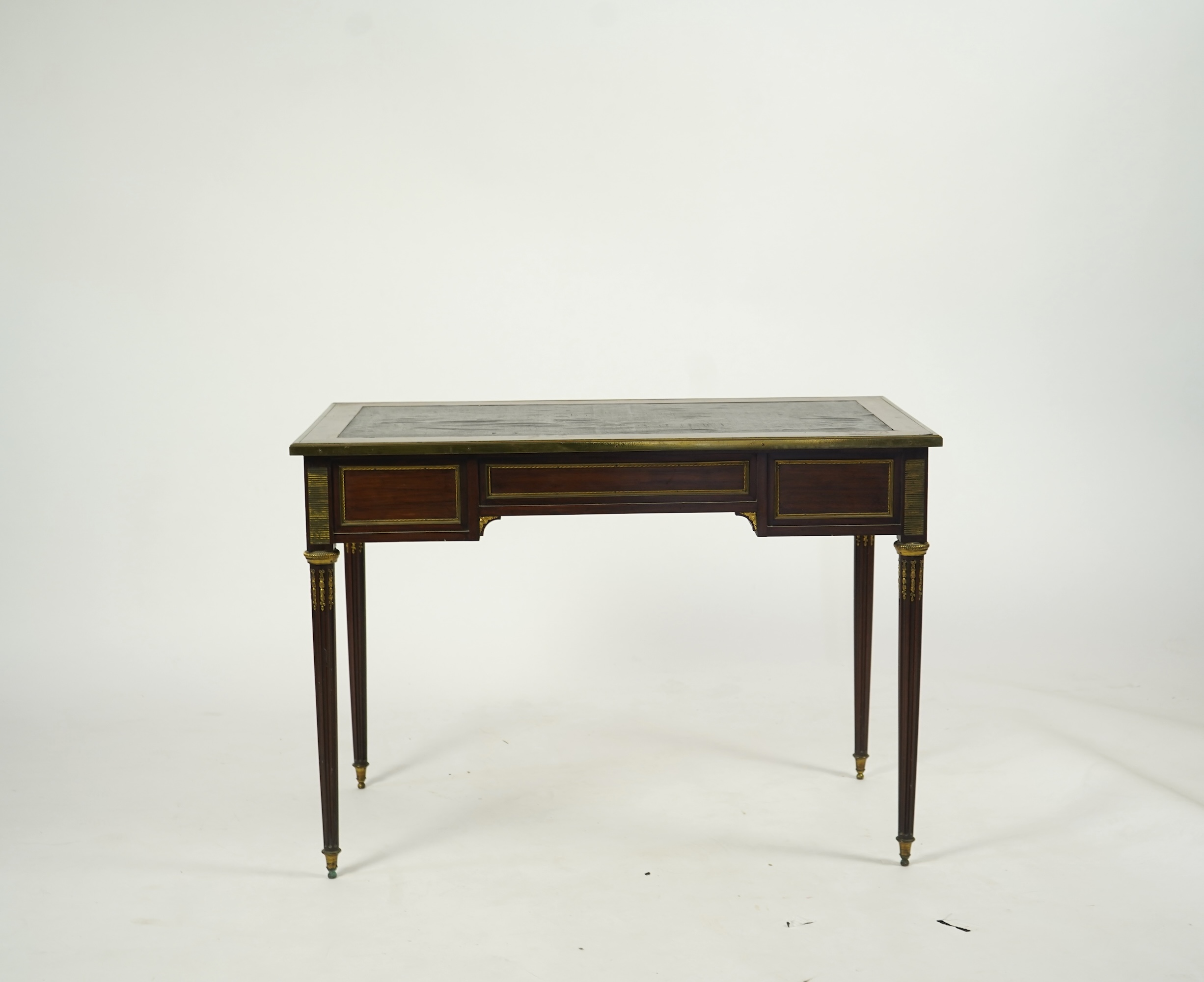 An early 20th century Louis XVI style brass mounted mahogany writing table